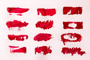 red oil paint brush strokes on paper.