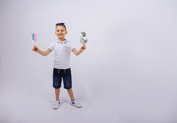 a boy in sunglasses on a white background holds a figure eight candy. Women's day, congratulations....