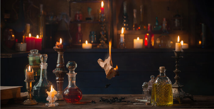old burning paper with potions on old wooden table