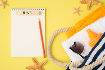 Top view photo of planner with inscription june pencil starfishes beach bag with towels orange bottle sunscreen and sunglasses on isolated yellow background with blank space