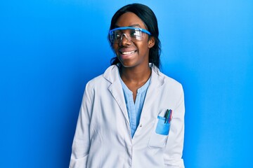 Young african american woman wearing scientist uniform looking to side, relax profile pose with...