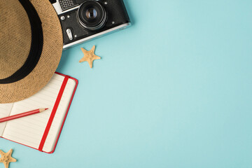 Top view photo of headwear camera red pencil planner and starfishes on isolated pastel blue background with copyspace