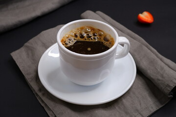 Black coffee on a black background. Delicious drink.