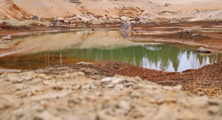 Dirty bottom of a dried-up lake. Ecological problems.