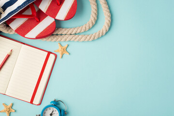 Top view photo of striped flip-flops in beach bag red copybook with pencil alarm clock and starfishes on isolated pastel blue background with copyspace