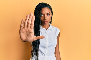 African american woman wearing casual clothes doing stop sing with palm of the hand. warning expression with negative and serious gesture on the face. - obrazy, fototapety, plakaty