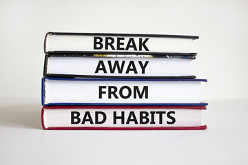 Break bad habits symbol. Books with words 'break away from bad habits'. Beautiful white background, copy space. Business, psychological and break away from bad habits concept.