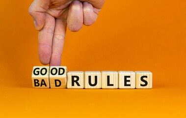 Good or bad rules symbol. Businessman turns wooden cubes and changes words 'bad rules' to 'good...