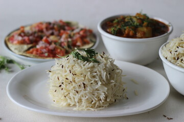Indian dish made of basmati rice flavoured with cumin seeds and spices. Served with Bottle Gourd Curry with Lentils and Crisp and fried papads topped with masala filling