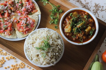 Indian dish made of basmati rice flavoured with cumin seeds and spices. Served with Bottle Gourd Curry with Lentils and Crisp and fried papads topped with masala filling
