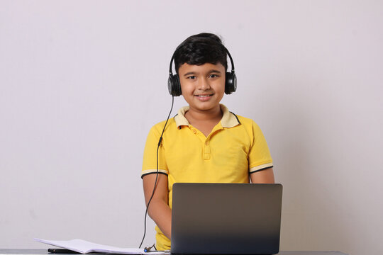 Indian Syudent Or Kid Attending Online School Using Computer Studying Using Laptop. 