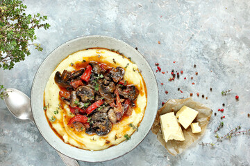corn porridge (polenta) with fried mushrooms and bell peppers. Served with grated parmesan.
top...