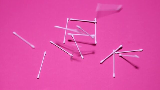 ear sticks on a pink cosmetics background