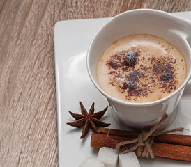 cup of coffee with cinnamon sticks