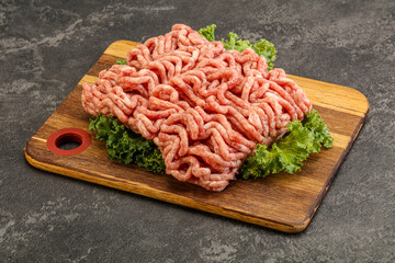 Raw pork minced meat over board