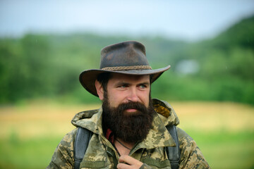 Hunting season. Animal Hunt. Brutal man poacher. Male adventures. Beard guy hiking with backpack....