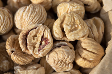 Close up and texture of dried chestnuts that are in a paper bag