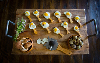 partridge eggs with truffle and mushroom served on a rustic tray