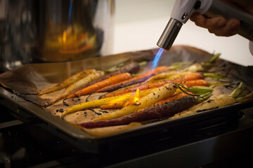 Assorted colorful carrots grilled on fire