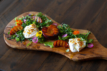 fresh colorful healthy salad served on a wooden board