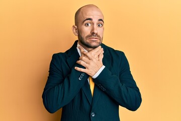 Young hispanic man wearing business suit and tie shouting and suffocate because painful strangle. health problem. asphyxiate and suicide concept.
