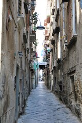 Fototapeta na wymiar Narrow dark alley in Naples, Italy