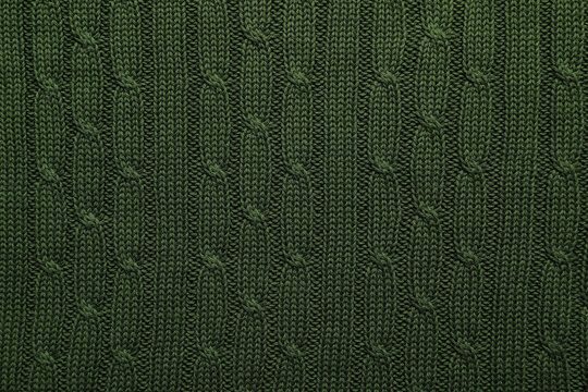 Dark green knitted wool texture as background, top view