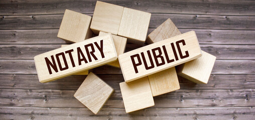 the word Notary Public written on wooden blocks and wooden background. Can be used for business,...