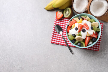 Fototapeta na wymiar Delicious fruit salad on grey table, flat lay. Space for text