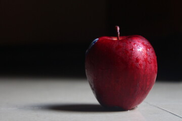 red apple on black background