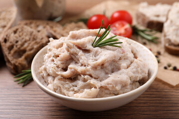 Delicious lard spread in bowl on wooden table, closeup