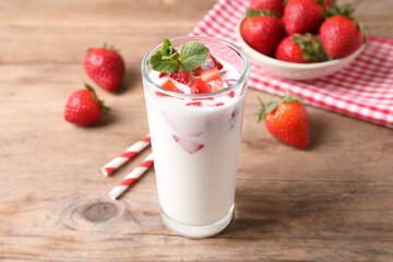 Delicious drink with strawberries on wooden table
