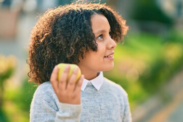 Adorable hispanic child girl smiling happy standing at the park