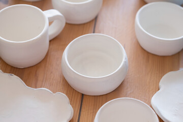 Handmade ceramics before firing standing on table