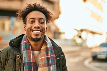Young african american man smiling happy standing at the city - Powered by Adobe