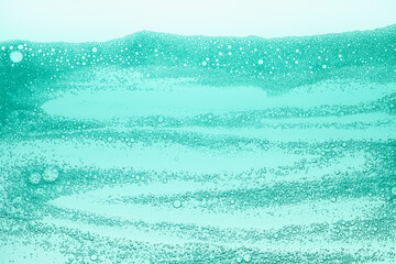 Fototapeta na wymiar Cream gel green foam transparent cosmetic sample texture with bubbles