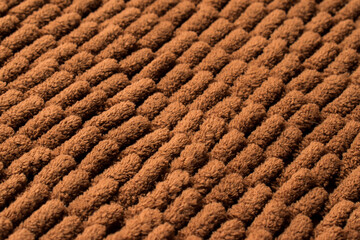 Close up of brown and soft rug texture with line pattern 