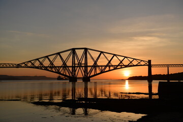 Fototapeta na wymiar Scotland's Forth Rail Bridge at sunrise from South Queensferry