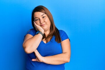 Fototapeta na wymiar Beautiful brunette plus size woman wearing casual blue t shirt thinking looking tired and bored with depression problems with crossed arms.