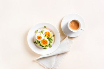 Avocado egg sandwich and cup of coffee