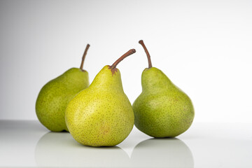 Pear, pakkham varieties, on a light background, with reflection