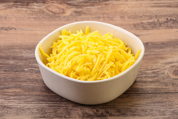 Shredded yellow cheese in the bowl
