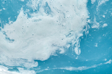 Liquid foam milk gel cosmetic smudge blue bath water background