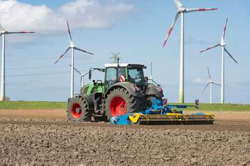 Tractor with power harrow in the field during soil cultivation | 1302