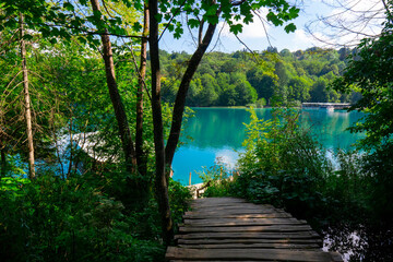 Croatia. Plitvice Lakes National Park. Walking wooden path along the lake with crystal turquoise water. Popular tourist spot. Listed as a UNESCO World Heritage Site