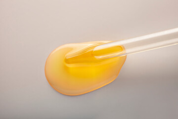 Liquid yellow gel or serum gray glass of microscope background
