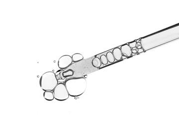 Liquid pipette gel or serum on white isolated glass of microscop background