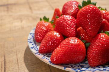 New harvest, plate of ripe red sweet strawberry ready to eat