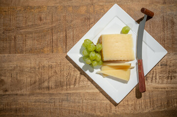 Cheese collection, piece of spanisch hard manchego cheese made in La Mancha region from sheep milk with green grapes