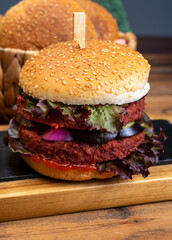 Tasty vegetarian cheeseburgers and hamburgers with round patties or burgers made from grains, vegetables and legumes